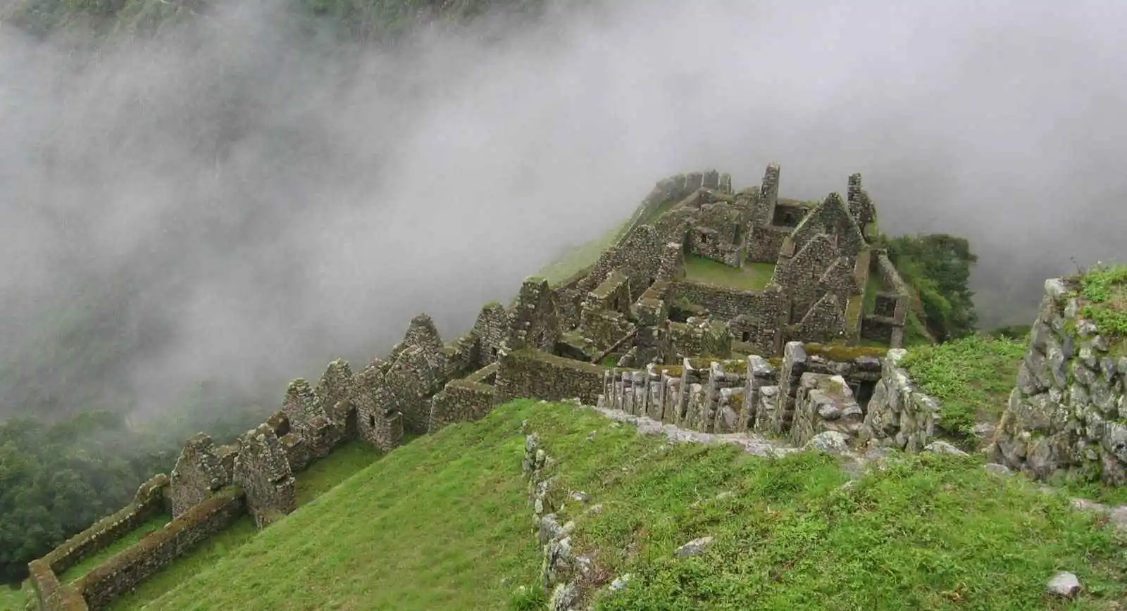 Wiñay Wayna archaeological site on the Inca Trail, showcasing ancient terraces, stone structures, and stunning Andean mountain views.