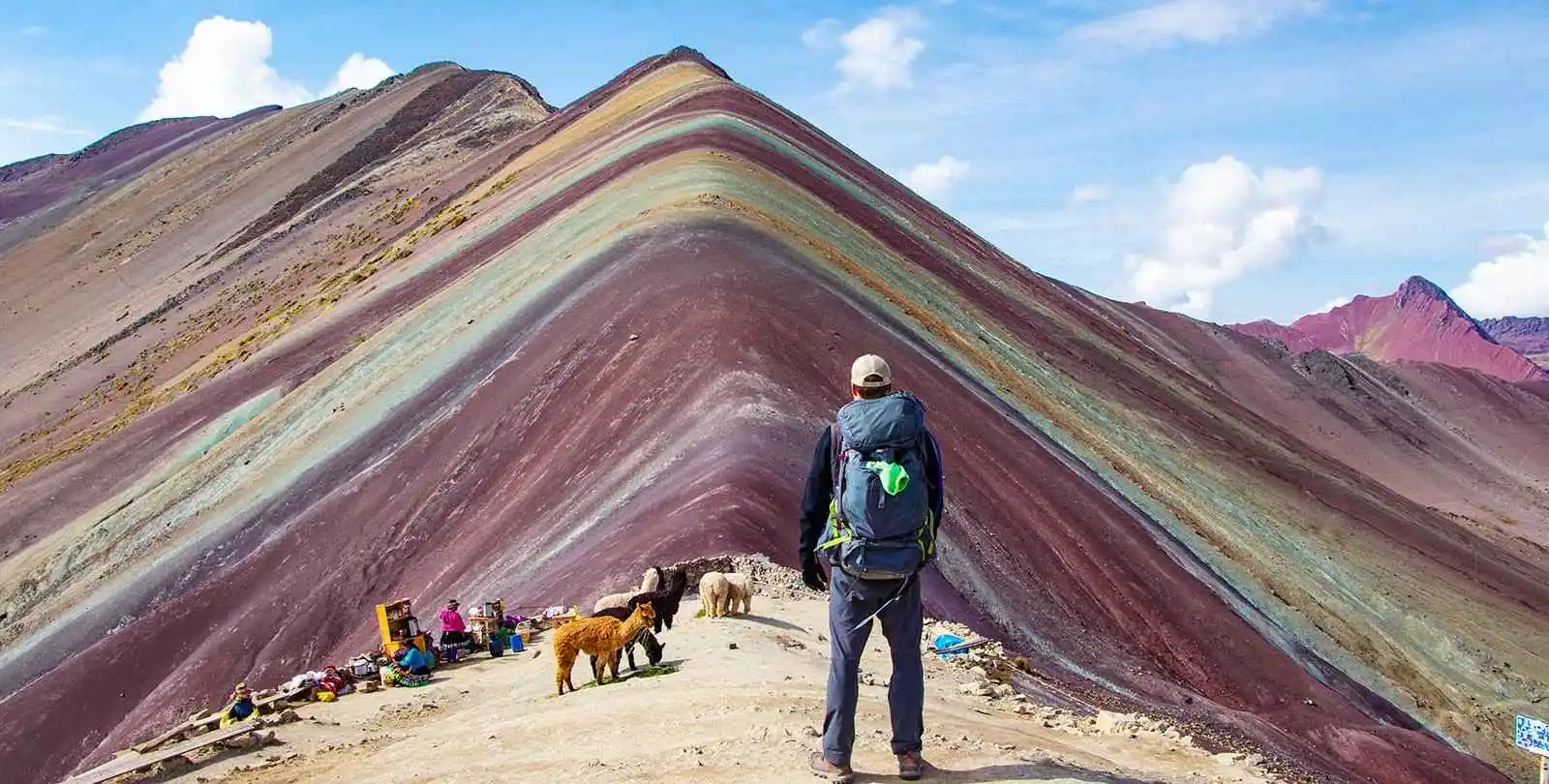 Rainbow Mountain (Vinicunca) in Cusco, Peru with vibrant colorful layers and tourists hiking