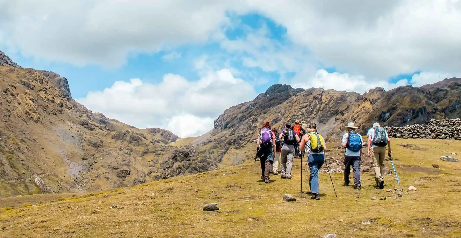 Hikers walking the Lares Trek through Andean villages, mountains, and serene valleys.