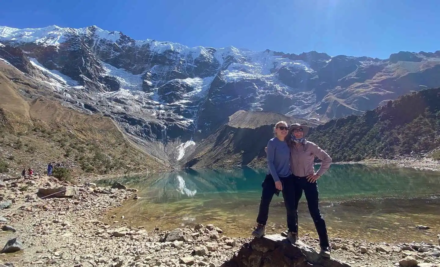 Hikers crossing dramatic Salkantay mountain passes with glaciers, rivers, and tropical cloud forests.